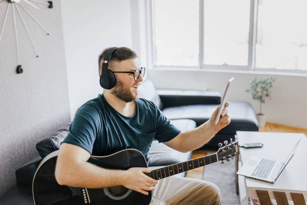 istock Acoustic guitar teaching through a video call 1369194289