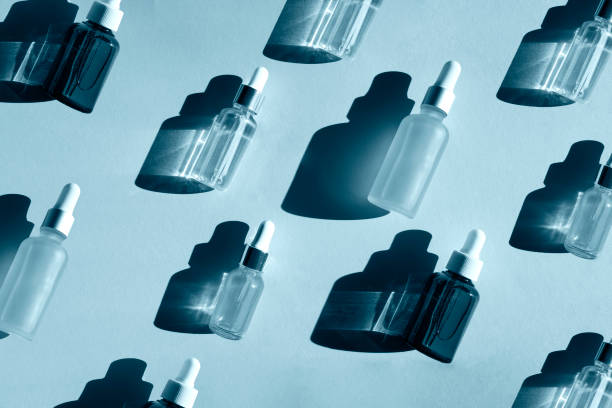 istock Bottles of oil on blue background 1369195876