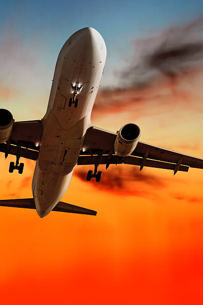 istock jet airplane landing at sunset 136919650