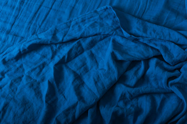 istock Crumpled linen texture in blue color. Background for your text.. 1369197062