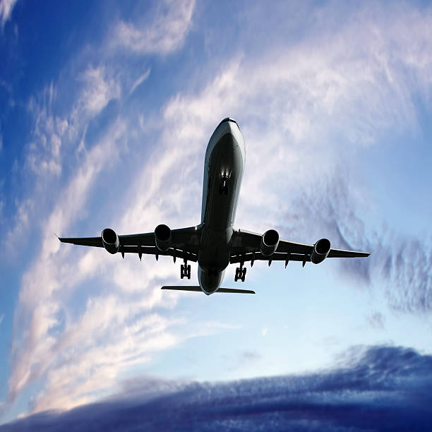 istock XL jet airplane landing at twilight 136919788