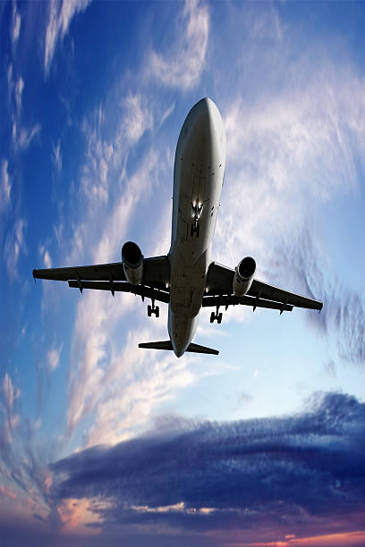 istock XL jet airplane landing at twilight 136919813
