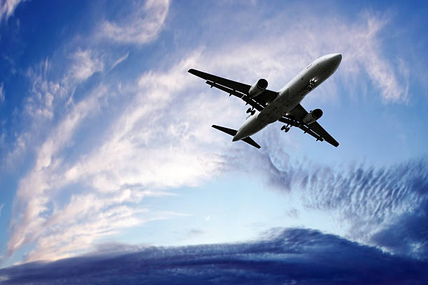 istock jet airplane landing at twilight 136919817