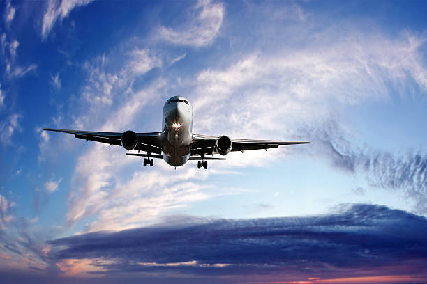 istock XL jet airplane landing at twilight 136919828