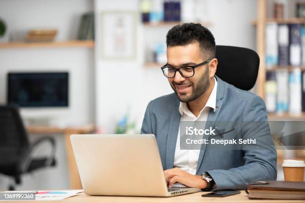 Portrait Of A Handsome Young Businessman Working In Office Stock Photo - Download Image Now