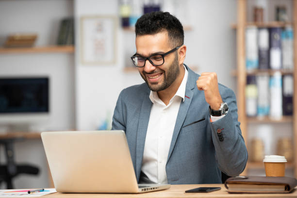 istock Portrait of a handsome young businessman working in office 1369199433