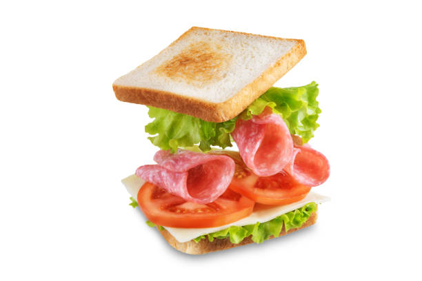 Sandwich with sausage, cheese and tomato on a white isolated background. toning. selective focus