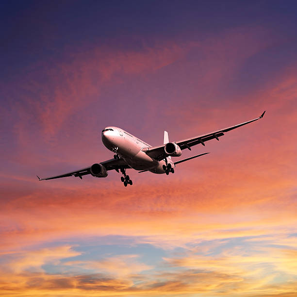 istock XL jet airplane landing at sunset 136920245