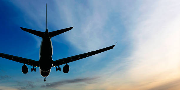 istock jet airplane landing at sunset 136920274