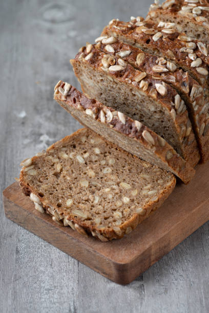 istock Sliced rye bread on cutting board. Whole grain rye bread with seeds 1369203291