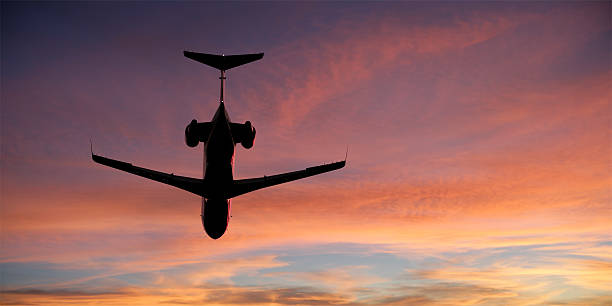 istock corporate jet airplane flying at sunset 136920360