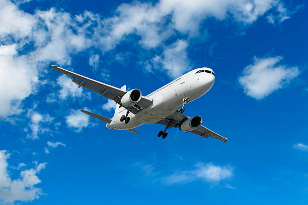 istock XL jet airplane landing in bright sky 136920387