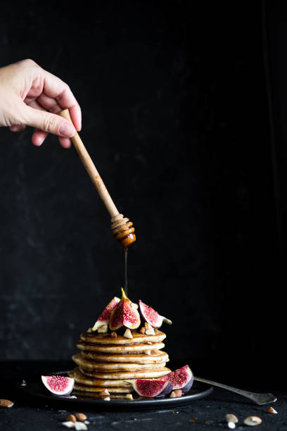 istock Fluffy buttermilk pancakes with figs and syrup pouring over 1369204330