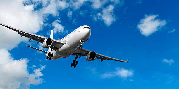 istock jet airplane landing in bright sky 136920468