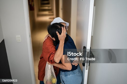istock Mother arriving home and being welcomed by daughter 1369204923