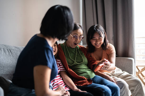istock Family using the mobile phone together at home 1369205018