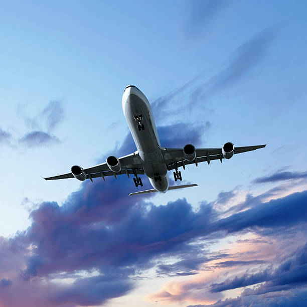 istock XL jet airplane landing at dusk 136920545