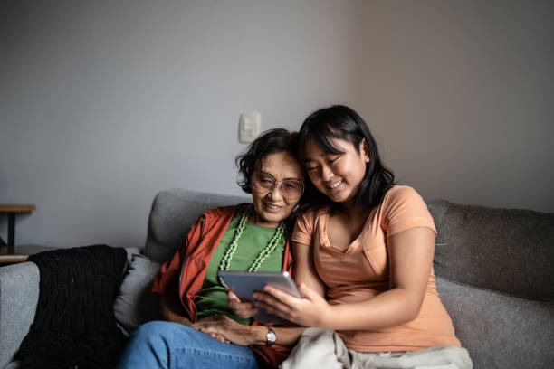 istock Grandmother and granddaughter using a digital tablet at home 1369205554