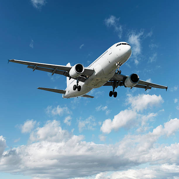 istock XL jet airplane landing in bright sky 136920574
