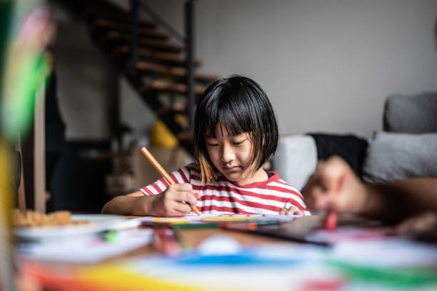 istock Girl drawing at home 1369205794