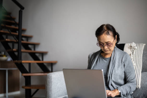 istock Senior woman using laptop at home 1369206766