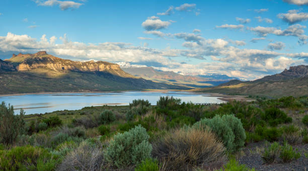 Panorama of the Absaroka Mountains of Wyoming above the Buffalo Bill Reservoir on a bright summer morning Panorama of the Absaroka Mountains of Wyoming above the Buffalo Bill Reservoir on a bright summer morning wyoming stock pictures, royalty-free photos & images