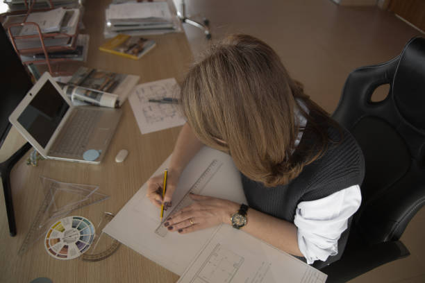 istock Woman architect working at home 1369207258