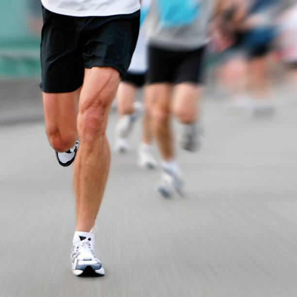 marathon runner long distance marathon runner in close-up with motion blur, square frame new york marathon photos stock pictures, royalty-free photos & images
