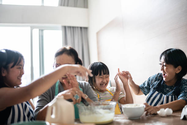 istock Happy family making mess while preparing a cake at home 1369209403