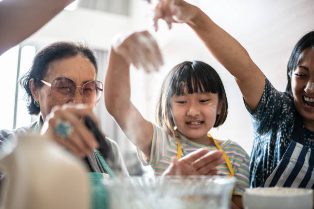 istock Happy family making mess while preparing a cake at home 1369209407