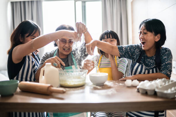 istock Happy family making mess while preparing a cake at home 1369209416