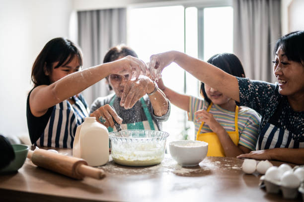 istock Happy family making mess while preparing a cake at home 1369209424