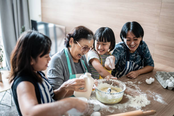 istock Happy family making mess while preparing a cake at home 1369209427