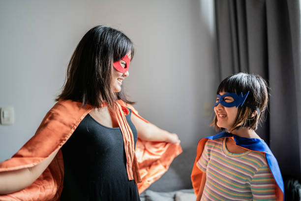 istock Sisters playing as superheroes at home 1369209485