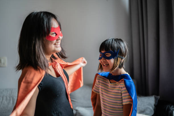 istock Sisters playing as superheroes at home 1369209493