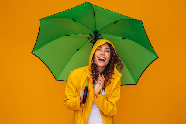 istock Girl with green umbrella 1369209572