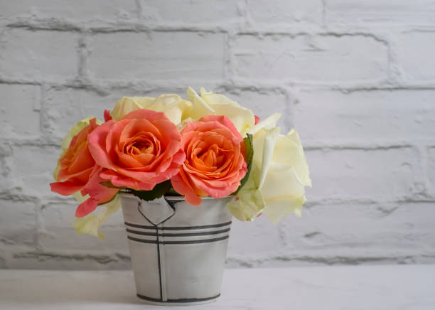 istock rose flower in vase on old background 1369209593