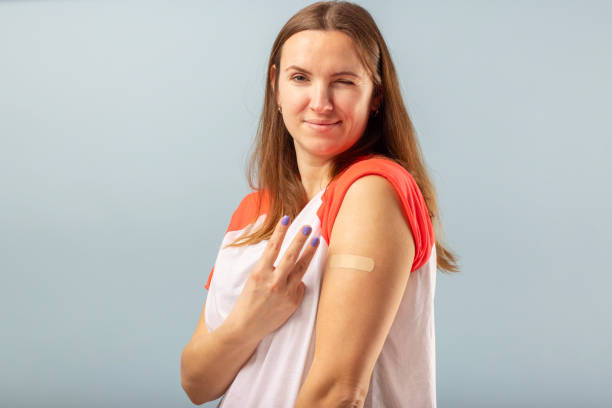 istock Coronavirus vaccination advertisement. Happy vaccinated woman after injection of third booster dose of coronavirus. Vaccination COVID-19 1369209607