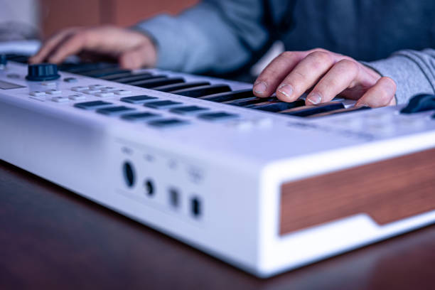 istock Close-up, male hands are playing the midi keyboard. 1369211053