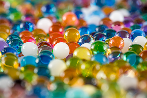 Water beads close-up, abstract background. Texture of Hydrogel balls or many colorful orbeez for wallpaper.