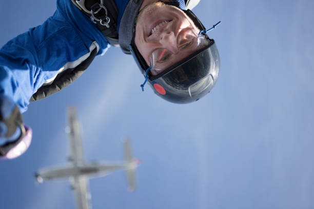 Selfie POV, as he flies through the sky, below airplane