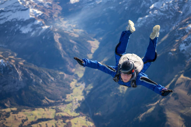 istock Skydiver falls through clear skies, aerial flight 1369213984
