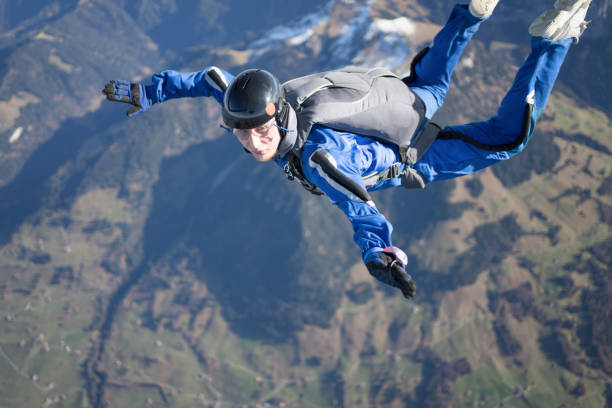 istock Skydiver falls through clear skies, aerial flight 1369214161