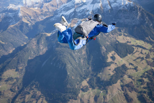 He flies through the sky, over the Swiss Alps