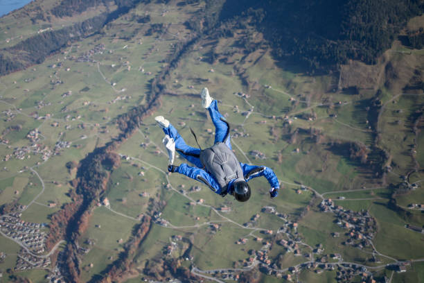 istock Skydiver falls through clear skies, aerial flight 1369214986