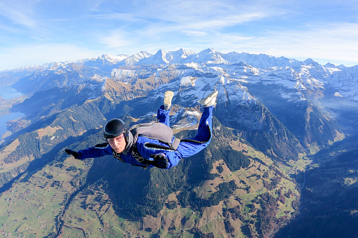 He flies through the sky, over the Swiss Alps