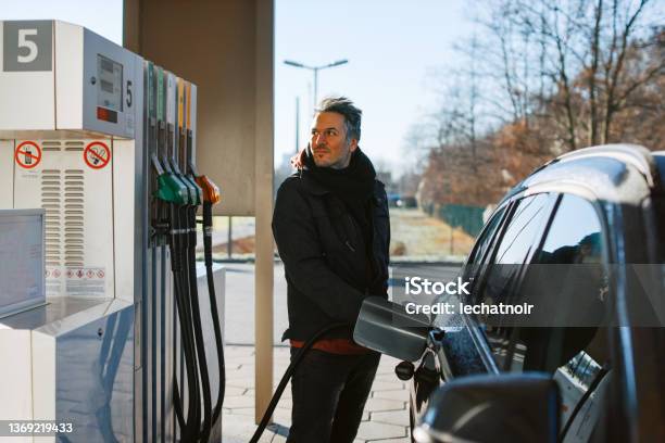 Man Filling A Tank With Fuel At The Gas Station In Berlin Stock Photo - Download Image Now