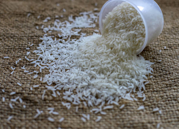istock Closeup of rice on burlap sack surface 1369219469