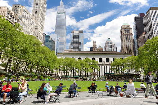 New York, USA - May 11, 2021: People are relaxing and enjoying nice sunny spring day in Bryant Park in Midtown Manhattan, New York City