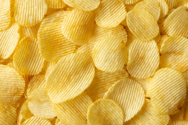 istock crispy golden potato chips snack texture background 1369223954